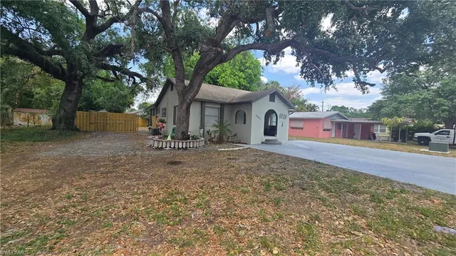 a backyard of a house with table and chairs