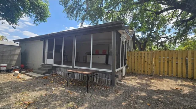 a view of a house with backyard and sitting area