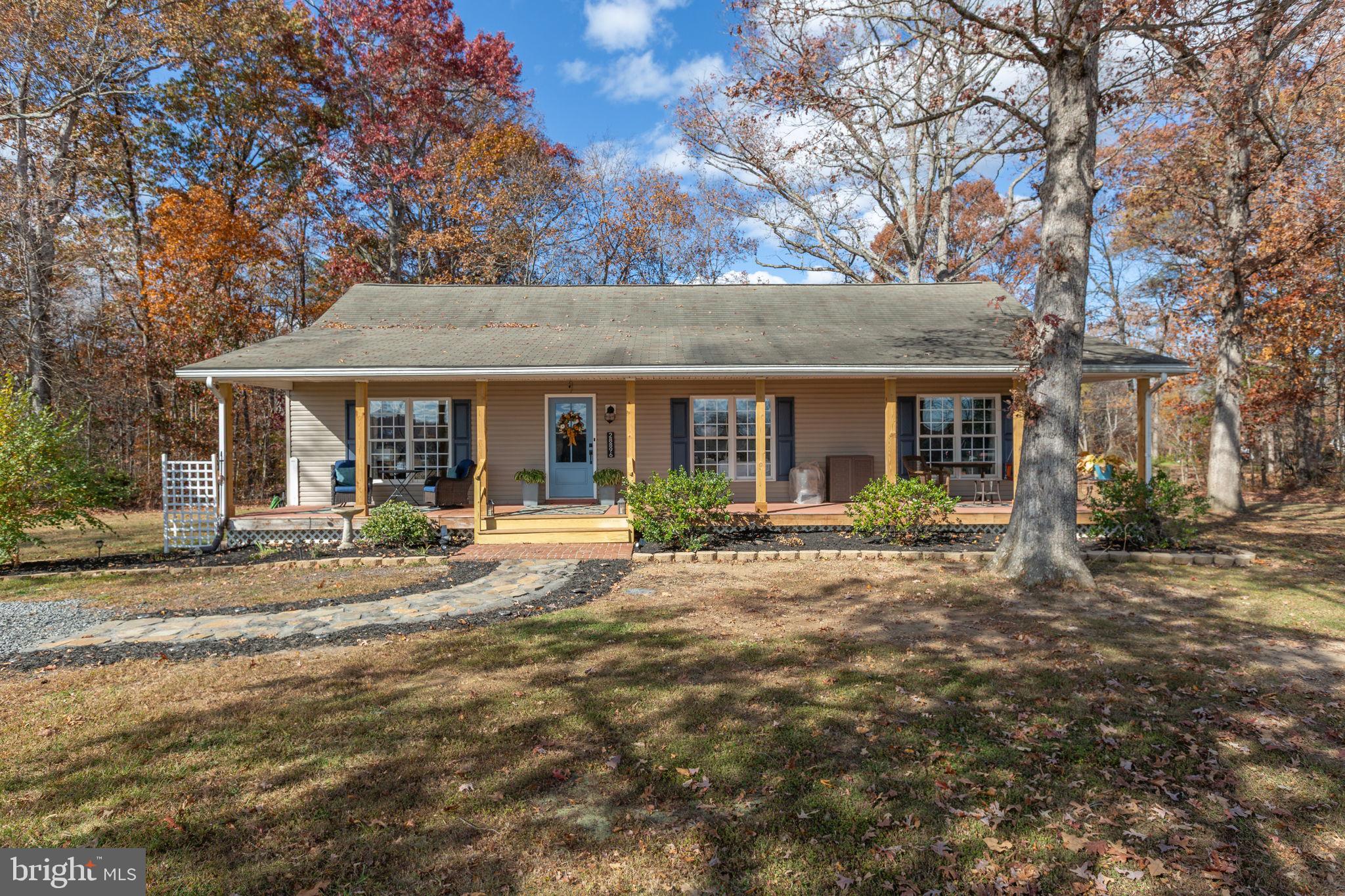 a front view of a house with yard patio and livingroom view