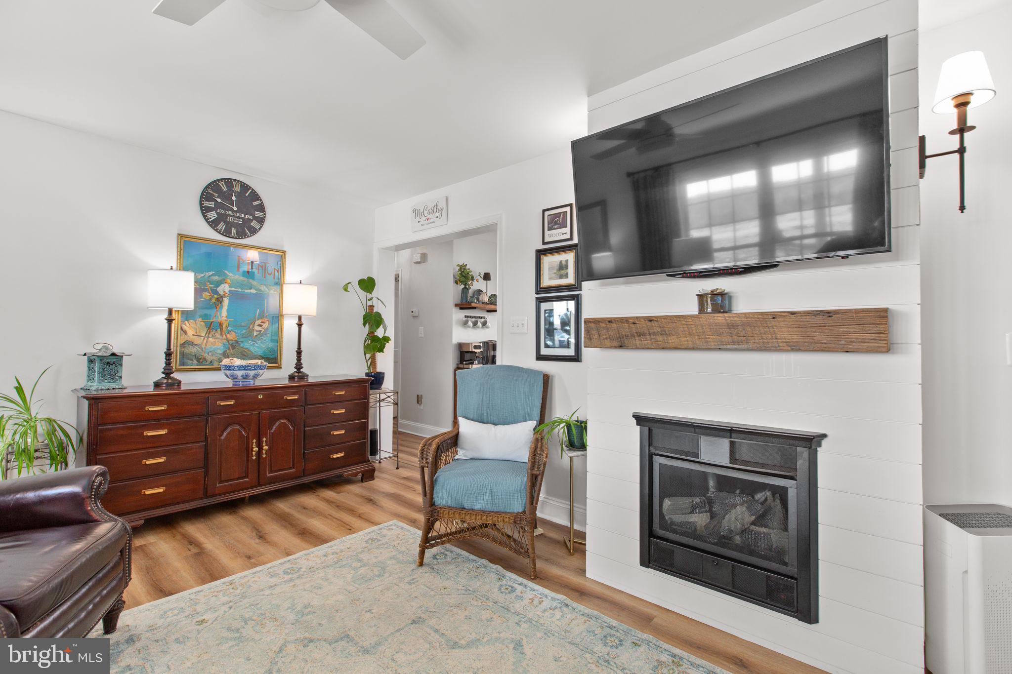 28896 Horseshoe Road Culpeper, VA 22701 - Photo 12 of 36 a living room with furniture a fireplace and a flat screen tv
