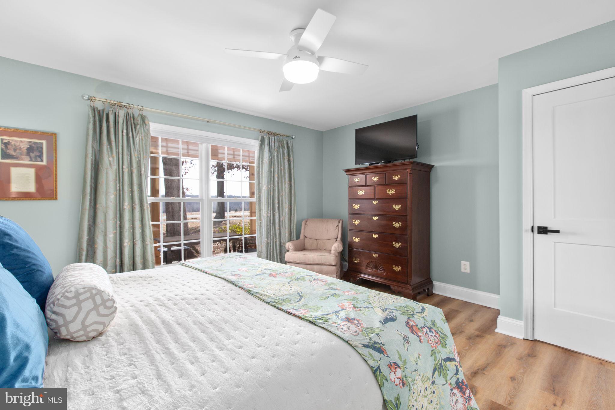 28896 Horseshoe Road Culpeper, VA 22701 - Photo 14 of 36 a bedroom with a bed and a flat tv screen on dresser