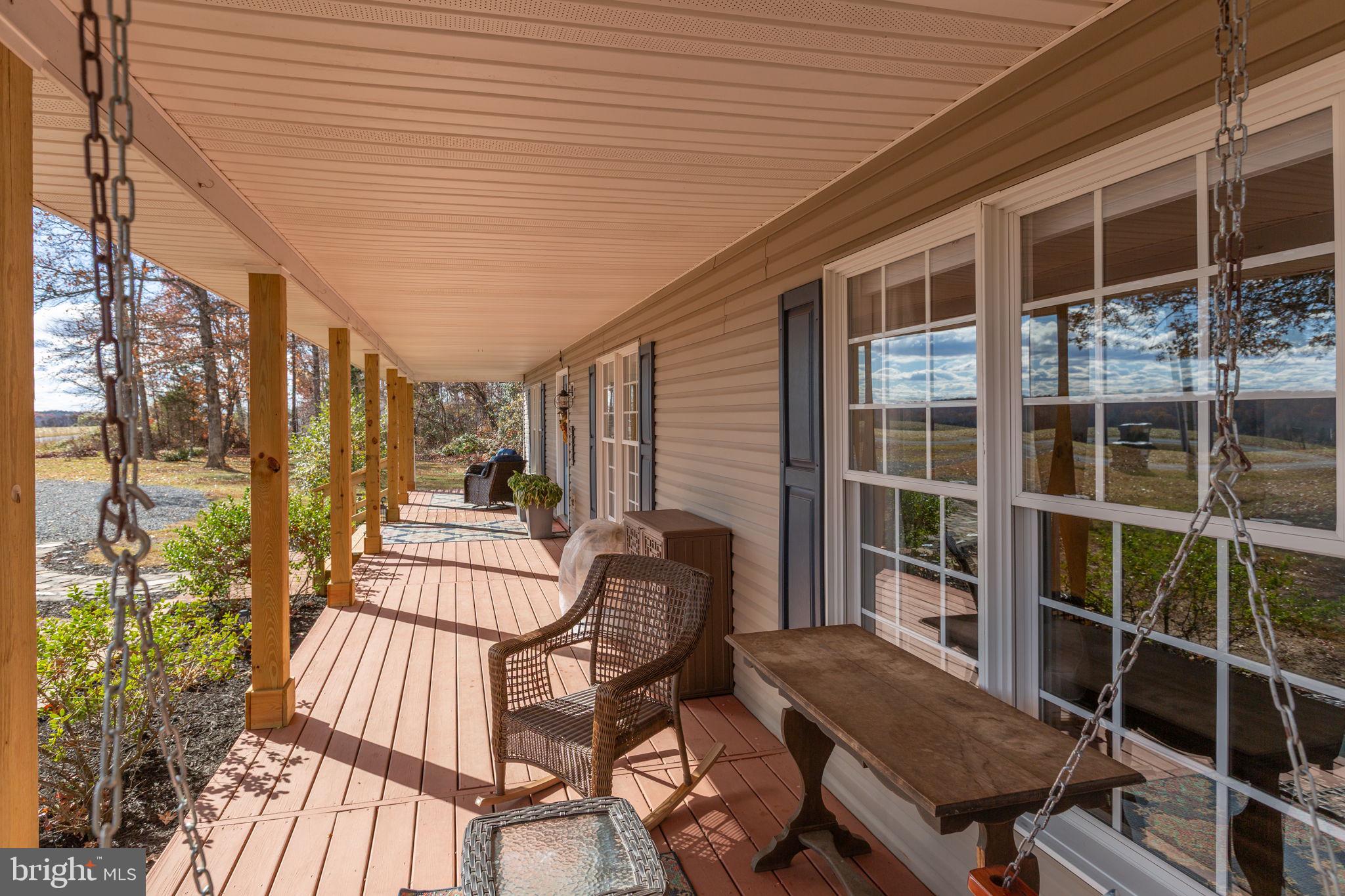 28896 Horseshoe Road Culpeper, VA 22701 - Photo 6 of 36 a roof deck with table and chairs and potted plants