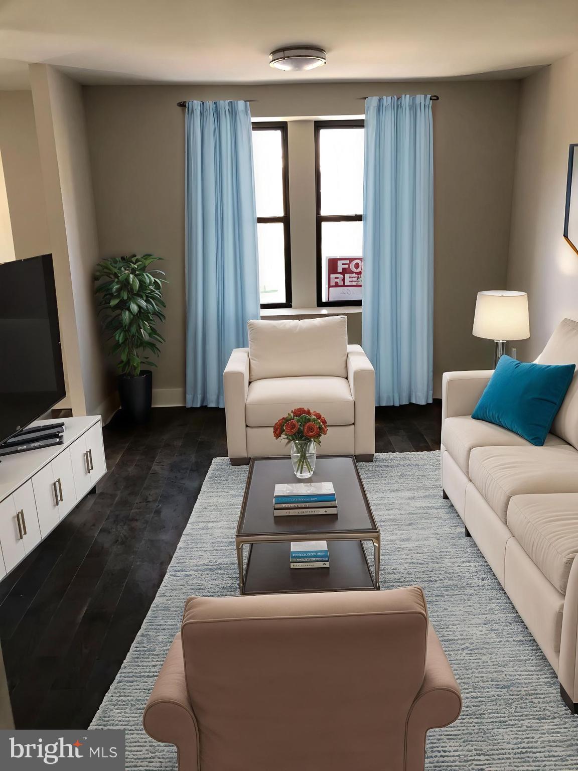 a living room with furniture and a flat screen tv