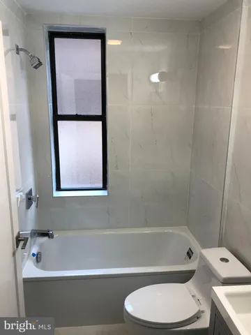 a bathroom with a toilet and a bathtub