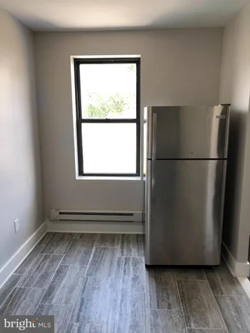 a view of a room with wooden floor and a window