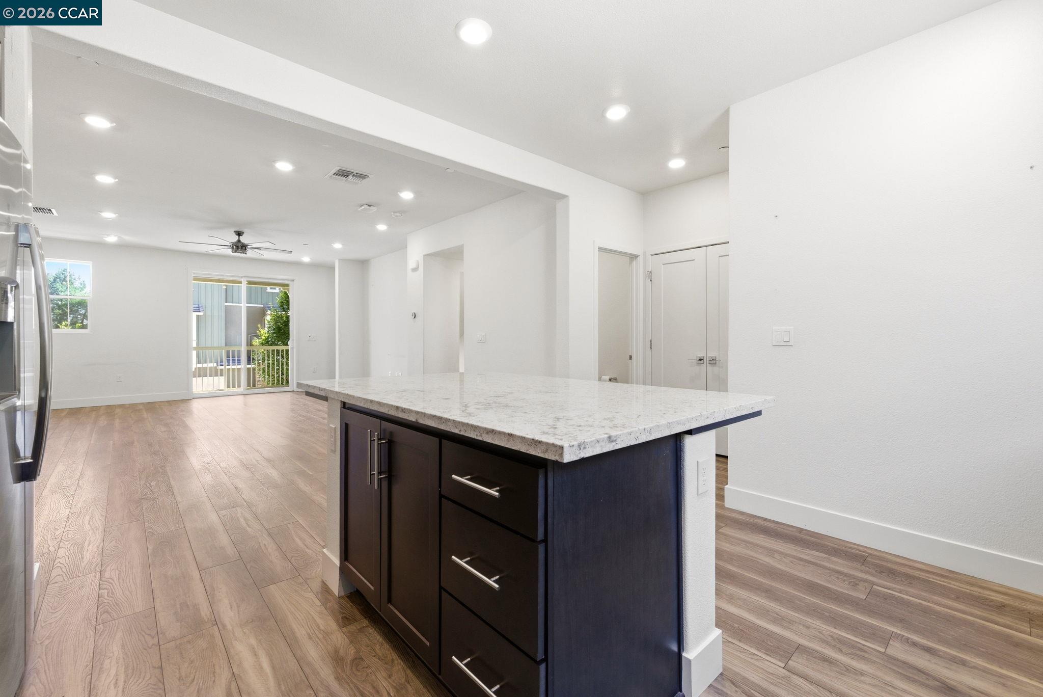 205 Plum Tree Street Livermore, CA 94551 - Photo 21 of 47 a kitchen with a wooden floor and window