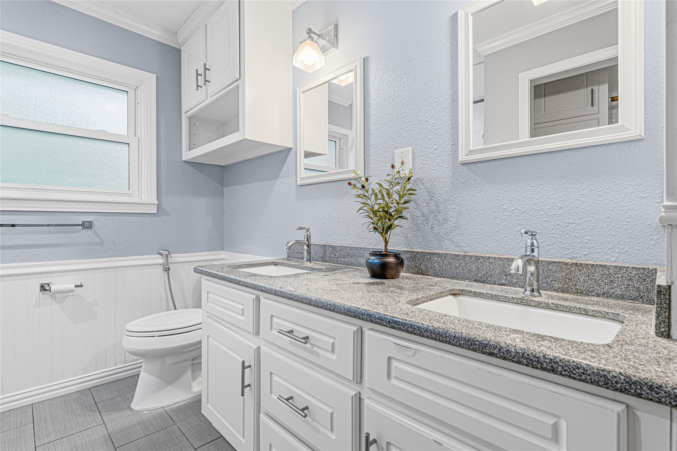 4002 Merrick Street Houston, TX 77025 - Photo 8 of 22 a bathroom with a granite countertop toilet sink and mirror