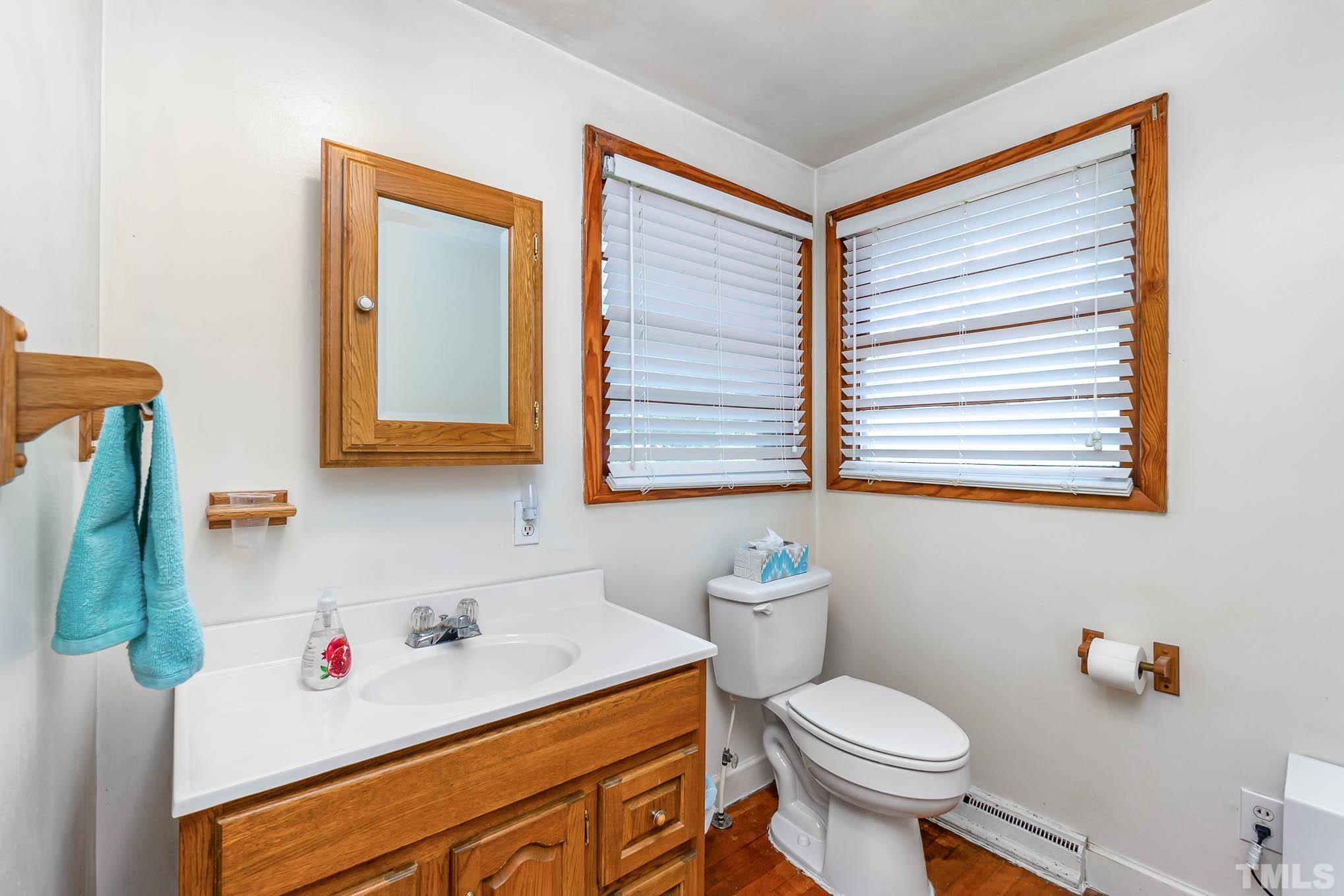 1921 Ebenezer Church Road Coats, NC 27521 - Photo 19 of 24 a bathroom with a sink toilet and a window