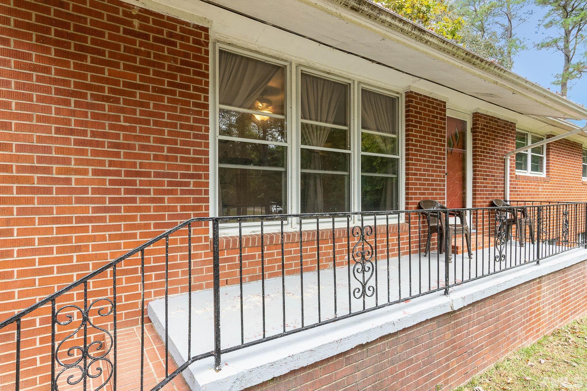 1921 Ebenezer Church Road Coats, NC 27521 - Photo 5 of 24 a view of a balcony with a floor to ceiling window next to a yard