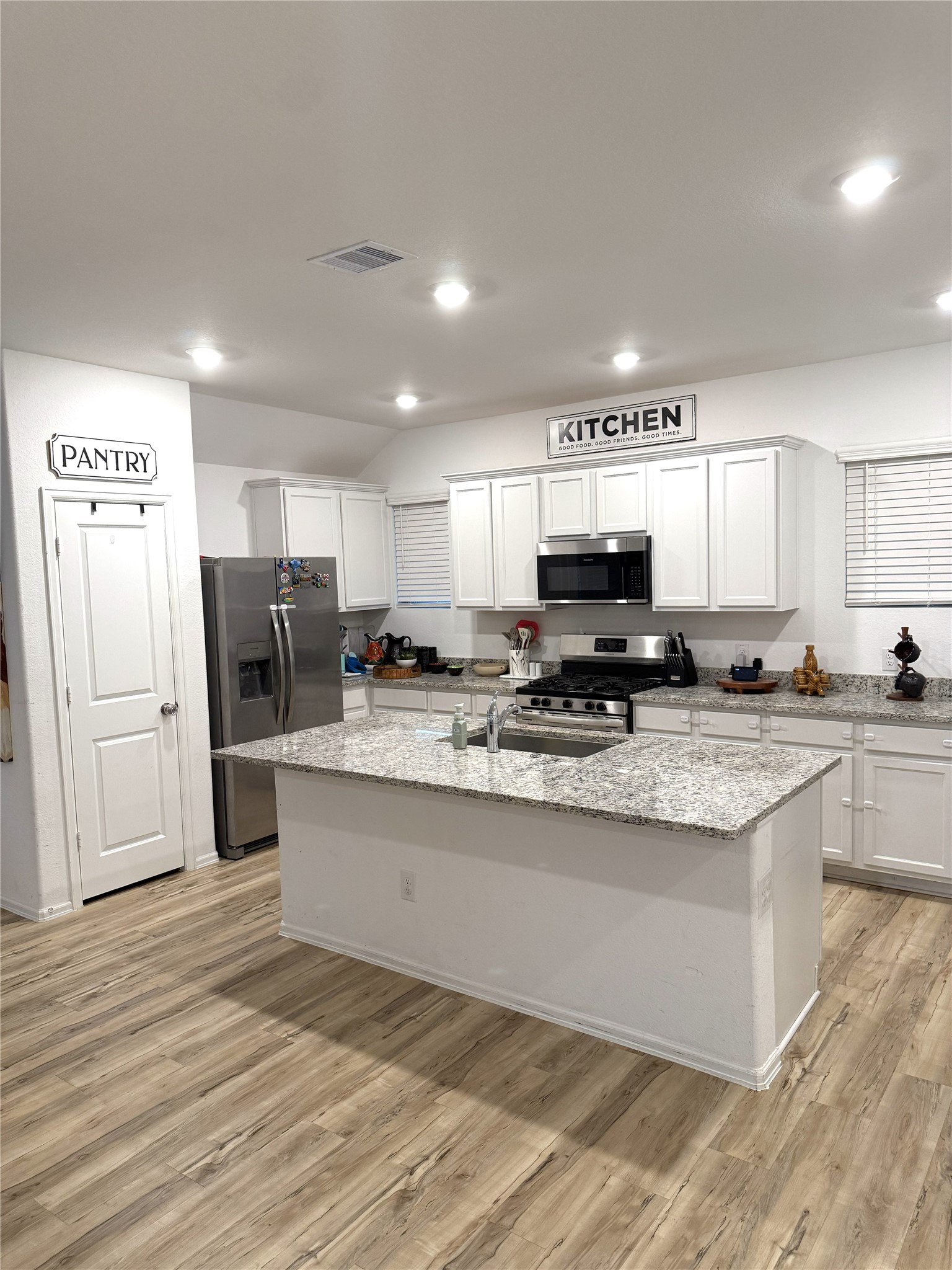 5323 Winding Strm Drive Rosenberg, TX 77469 - Photo 7 of 13 a kitchen with stainless steel appliances granite countertop a refrigerator sink and white cabinets