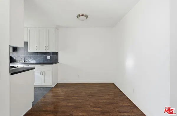 a view of a kitchen with sink and cabinets