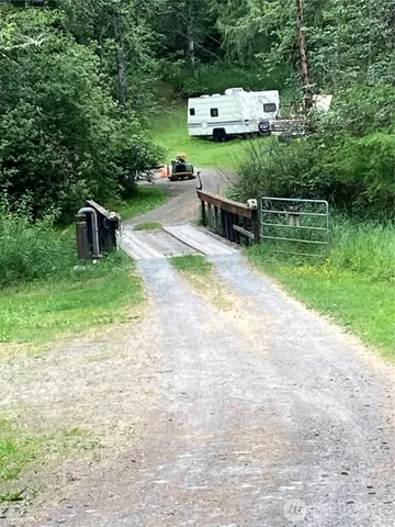a backyard of a house with outdoor seating and trees