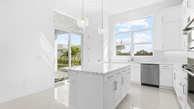 a kitchen with white cabinets and white appliances