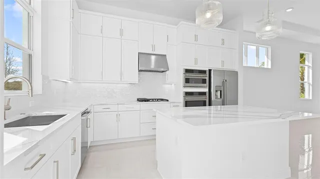 a kitchen with cabinets appliances and a sink