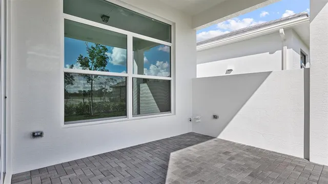 a view of a bedroom with wooden floor and windows