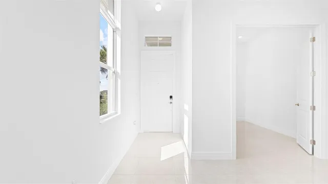 a view of an empty room with windows