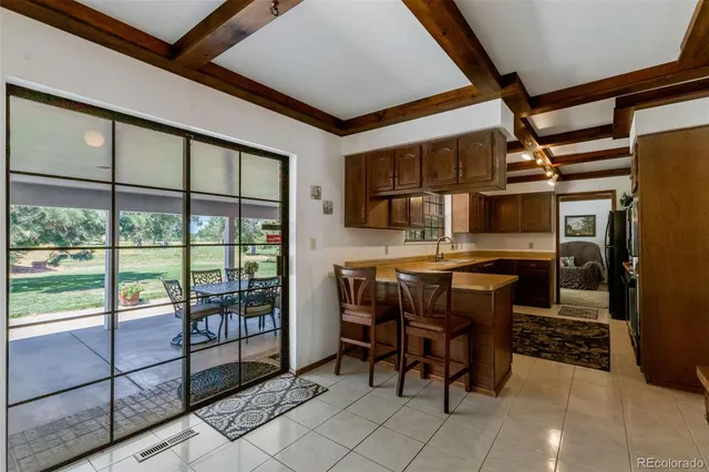 a room with stainless steel appliances kitchen island granite countertop furniture and a sink