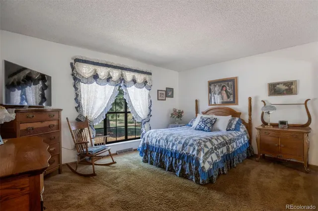 a bedroom with a bed and a flat tv screen