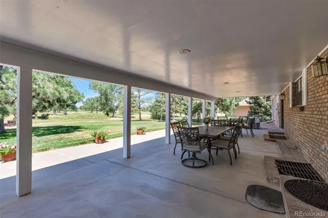 a dining room with furniture and a garden view