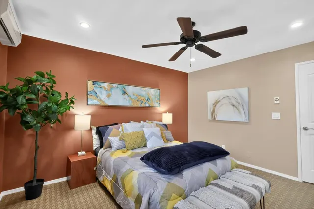 a bedroom with a bed and a potted plant