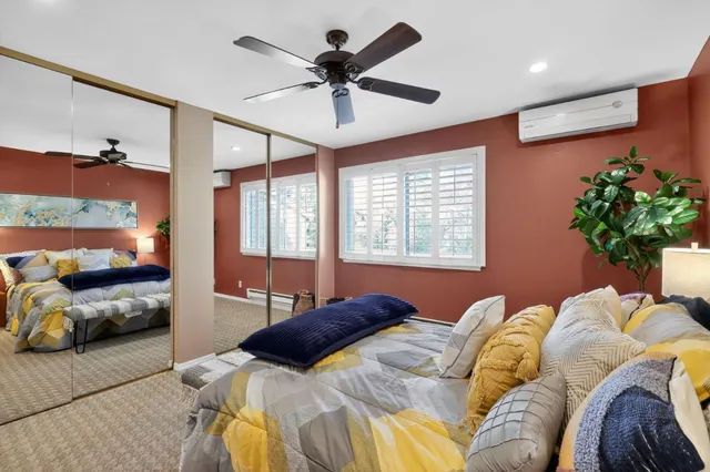 a bedroom with a bed and ceiling fan