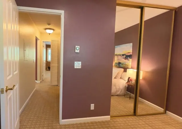 a view of a hallway with a furniture and front door