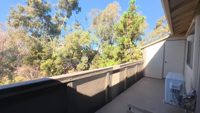 a view of balcony with wooden floor