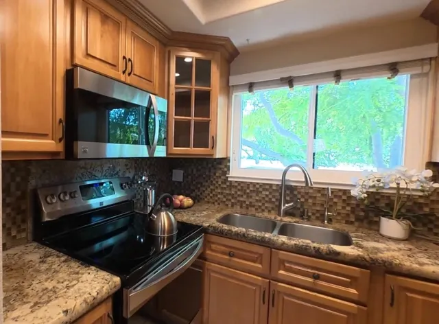 a kitchen with a sink and wooden cabinets