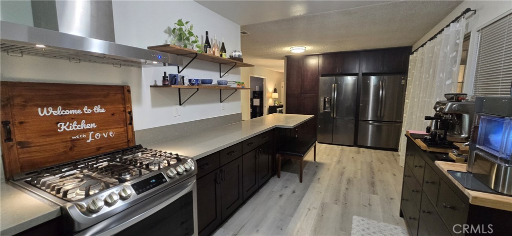 6830 Astoria Drive Riverside, CA 92503 - Photo 12 of 23 a kitchen with stainless steel appliances kitchen island a stove and a refrigerator