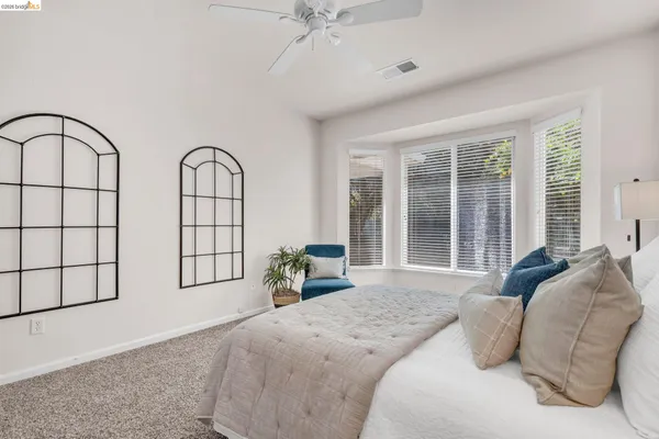 a bedroom with bed and a window