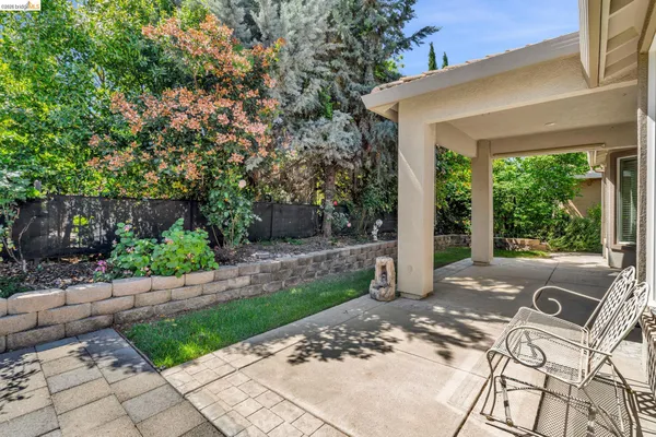 a view of a patio with table and chairs couches and potted plants
