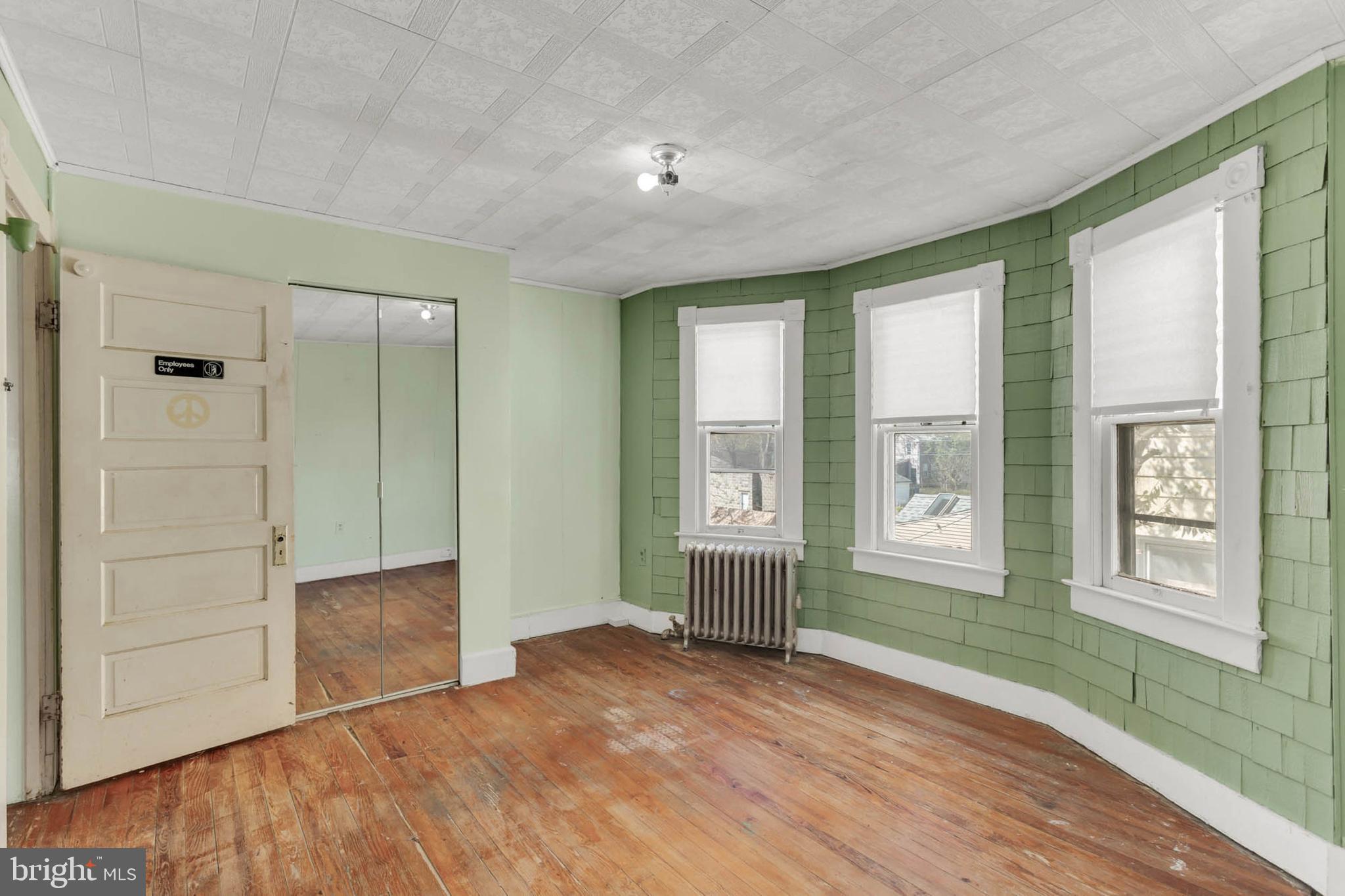 3724 5th Street Baltimore, MD 21225 - Photo 17 of 30 an empty room with windows and closet