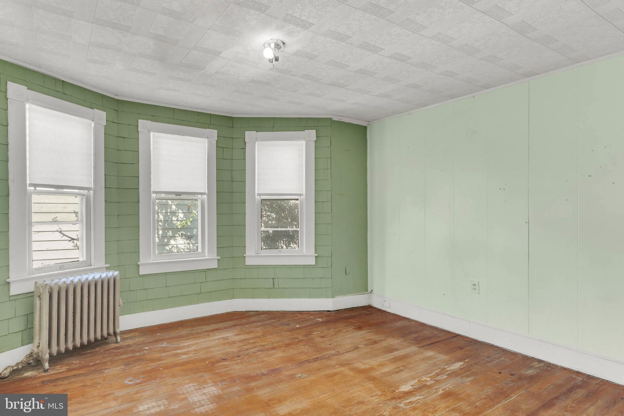 3724 5th Street Baltimore, MD 21225 - Photo 18 of 30 an empty room with wooden floor and windows