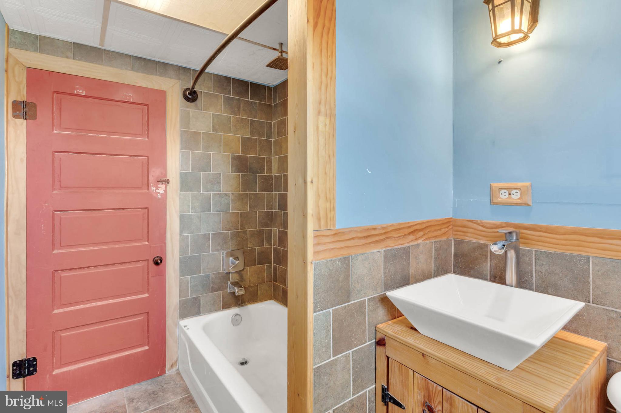 3724 5th Street Baltimore, MD 21225 - Photo 19 of 30 a bathroom with a bathtub and shower