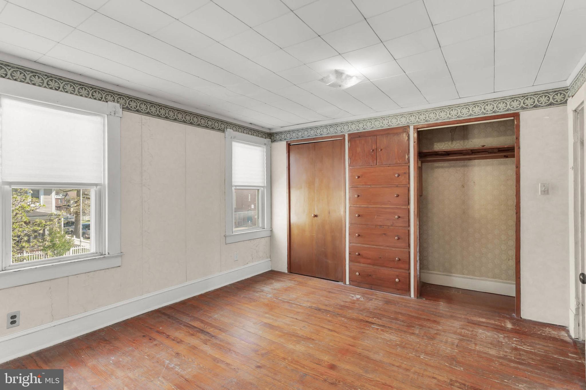 3724 5th Street Baltimore, MD 21225 - Photo 21 of 30 an empty room with wooden floor closet and windows