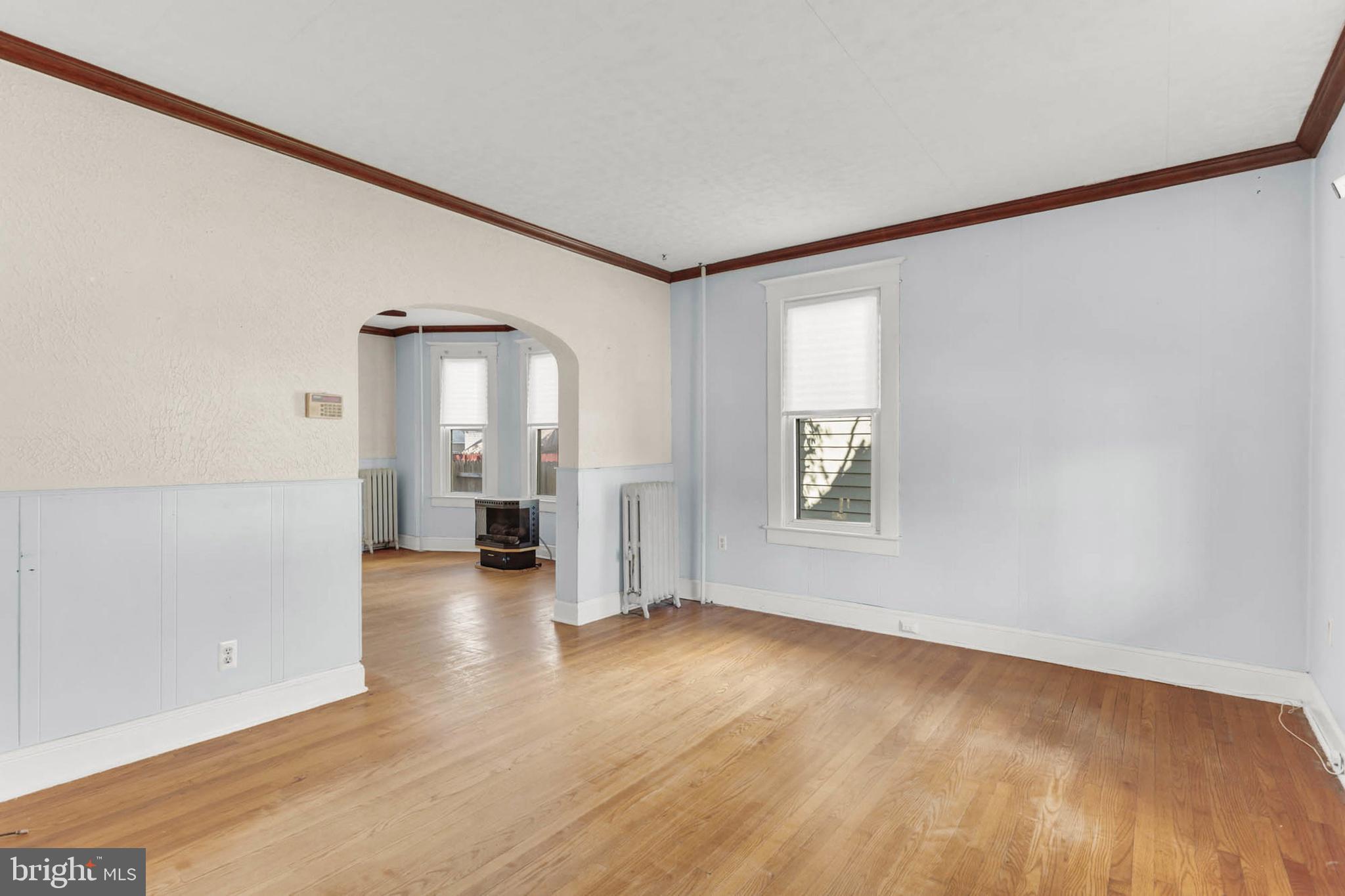 3724 5th Street Baltimore, MD 21225 - Photo 5 of 30 an empty room with wooden floor and windows