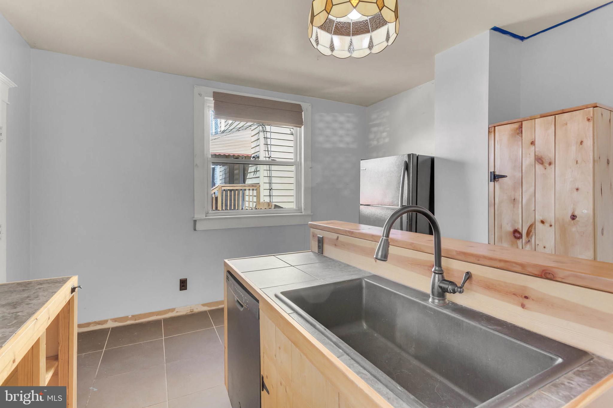 3724 5th Street Baltimore, MD 21225 - Photo 10 of 30 a kitchen with a sink cabinets and a granite counter top