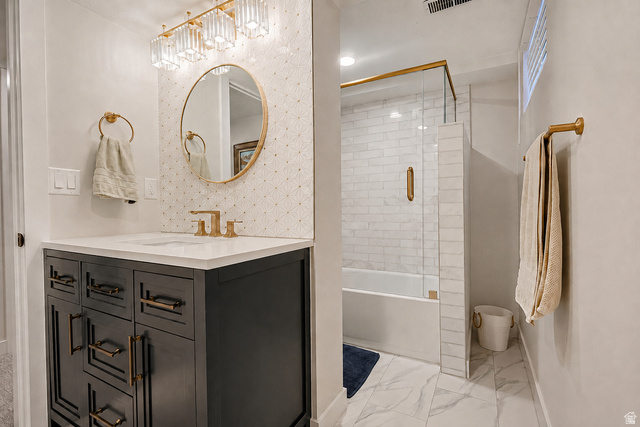 2924 Robidoux Road Sandy, UT 84093 - Photo 43 of 68 Vanity with a white countertop and gold-finish fixtures