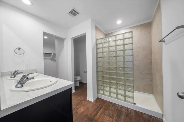 a bathroom with a sink shower and a mirror