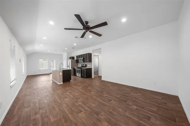 a view of kitchen with stove and wooden floor