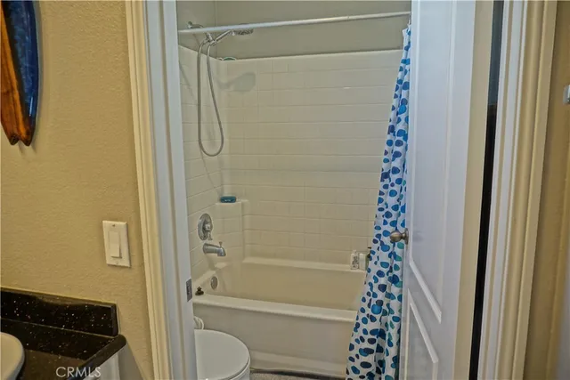 a bathroom with a shower curtain and a window