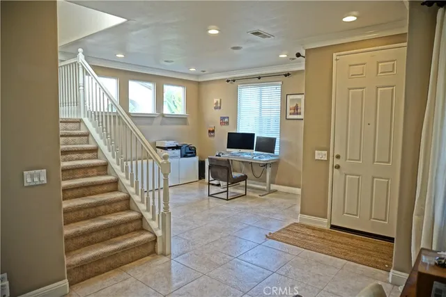 a view of a hallway with wooden floor and stairs