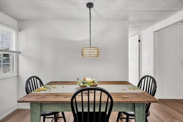 a view of a dining room with furniture wooden floor and a chandelier