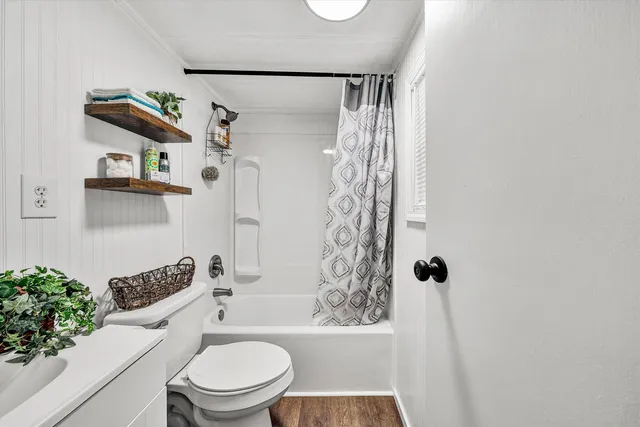 a bathroom with a toilet a sink and a shower
