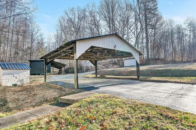 a view of a house with a yard and wooden fence