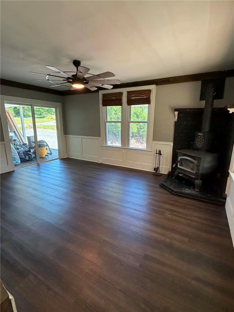 164 Sand Spring Road Cresco, PA 18326 - Photo 33 of 60 The living area presents dark wood flooring and a classic wood-burning fireplace.