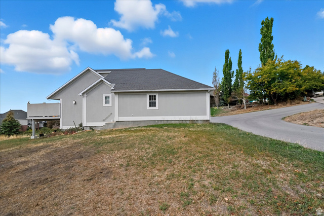 2887 View Crest Circle North Logan, UT 84341 - Photo 37 of 37 View of side of home featuring a yard and roof with shingles