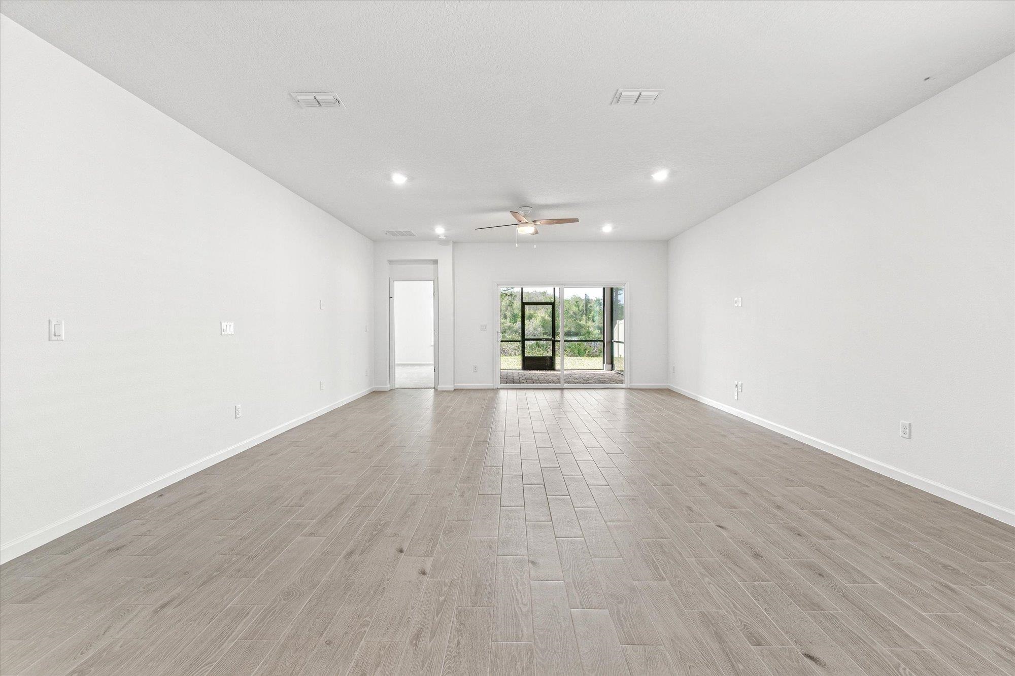 89 Kingsley Pk Way St. Augustine, FL 32084 - Photo 10 of 67 wooden floor in an empty room with a window