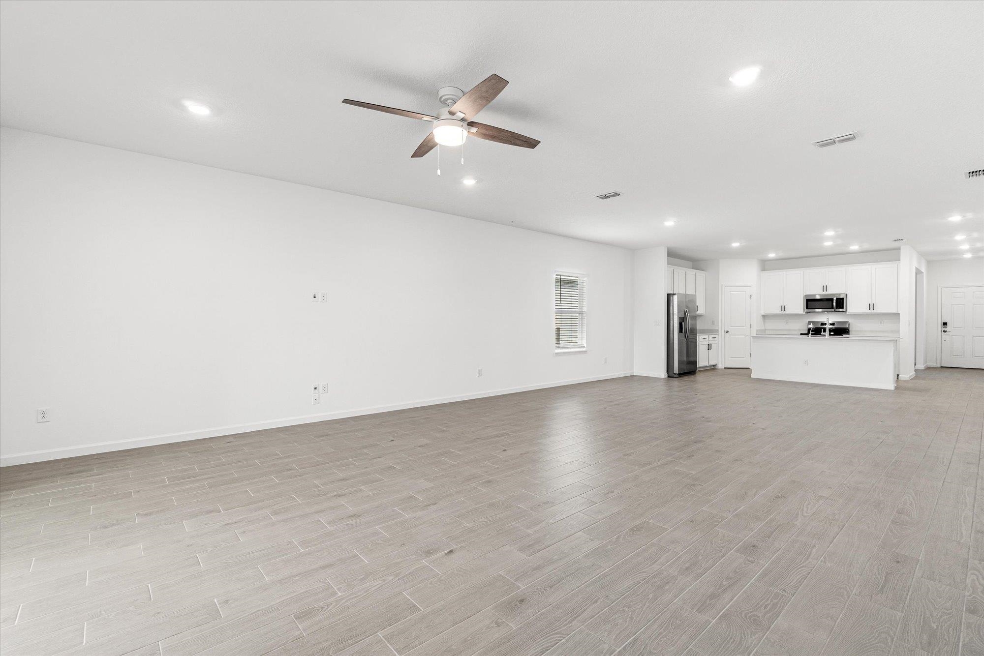 89 Kingsley Pk Way St. Augustine, FL 32084 - Photo 13 of 67 Unfurnished living room featuring recessed lighting, a ceiling fan, and light wood-style flooring