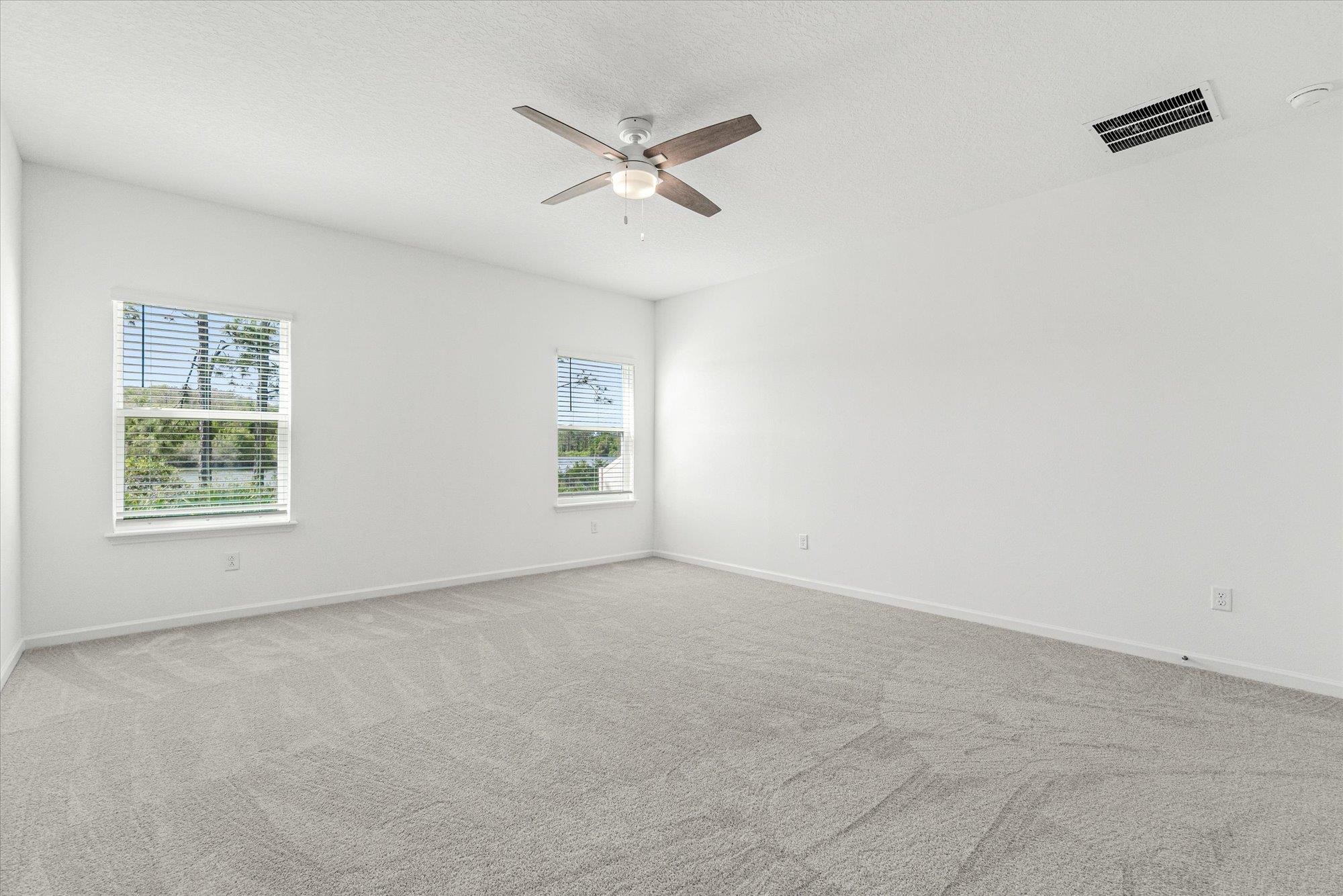 89 Kingsley Pk Way St. Augustine, FL 32084 - Photo 16 of 67 an empty room with windows and fan